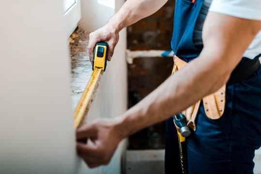 Handyman with tool belt ready to repair a home